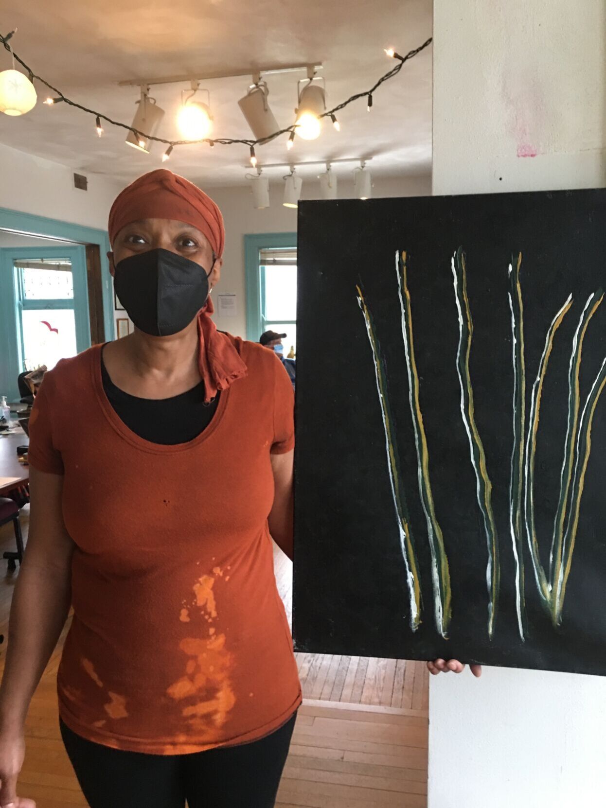 Fee Buchanan with painting by Scott Hansen
